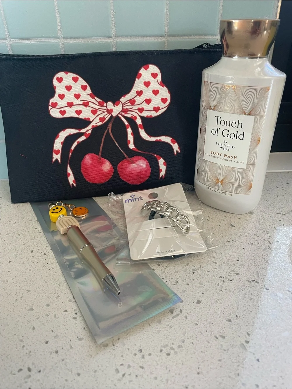 Black Cosmetic Bag Red Cherry Bow Design. Includes body wash, pen, and hair tie - Picture 1 of 2